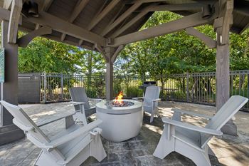 Gas grills, fire pit, and hammocks at pool area